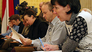 group of journalists sitting and writing