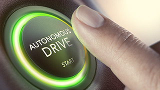 Finger pressing a button "Autonomous Drive"