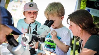 Kinder schauen in ein Mikroskop