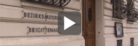 Videoausschnitt mit Play-Button: Eingang zum Bezirksmuseum Brigittenau