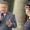 Bürgermeister Michael Ludwig hält ein Mikrofon in der Hand und blickt zu einem Polizisten