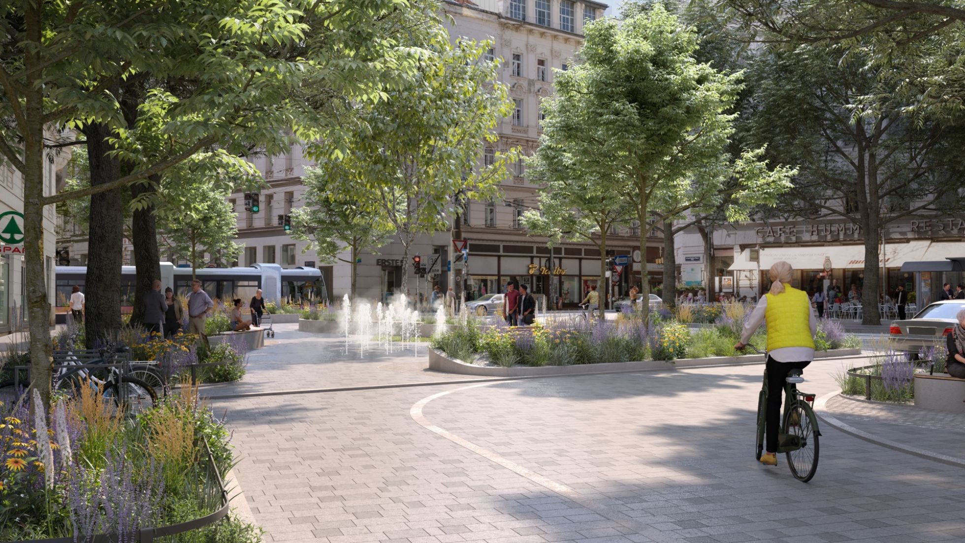 Eine Radfahrerin fährt zwischen Bäumen auf einem begrünten Platz zu