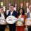copyright: Stadt Wien/Martin VOTAVA Jürgen Czernohorszky, Saya Ahmad, Wilfried Zankl und Dietmar Baurecht stehen nebeneinander und halten je eine Schachtel mit Aufdruck "Klimateam" in den Händen