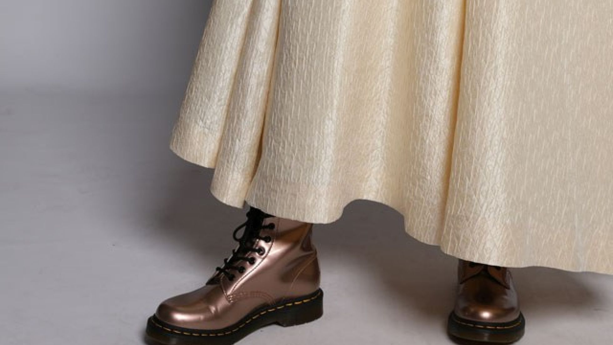 Schillerndes, weißes Kleid mit bronze-farbenen, robusten Schnür-Stiefeln