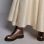 Schillerndes, weißes Kleid mit bronze-farbenen, robusten Schnür-Stiefeln