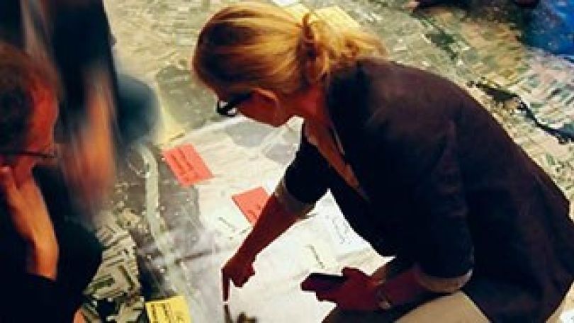 copyright: Fürthner Eine Frau weist auf einen bestimmten Punkt auf einem Plan hin.