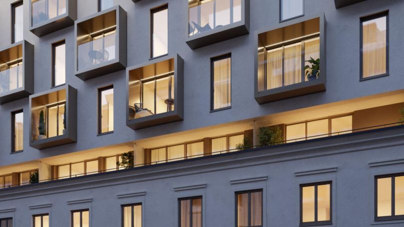 Fassade eines sanierten Gebäudes mit Dachgeschoßausbau.