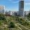 copyright: Stadt Wien/Petra Dworzak 2 höhere Gebäude, dazwischen etwas niedrigere, davor ein grüner Park mit Wegen.