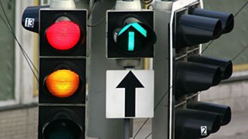 Ampelanlage: Ampel, die von Rot auf Gelb springt, neben Ampel, die Grün für die Geradeausspur anzeigt