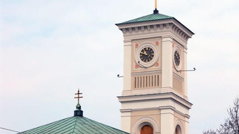 Außenansicht einer Kirche mit einem Turm mit Uhr