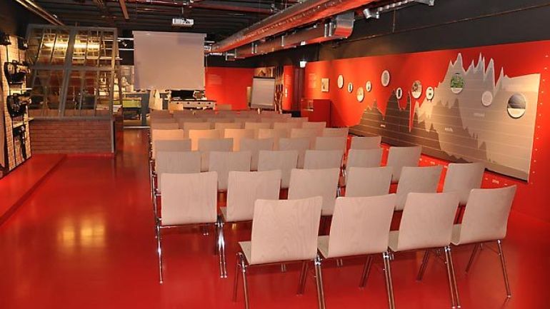 copyright: MA 34 - Bau- und Gebäudemanagement Roter Seminarraum mit Stühlen und Leinwand