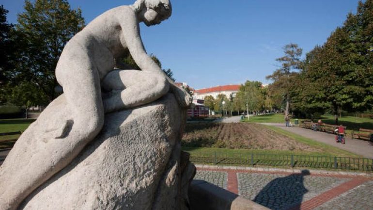 A fountain with a stone statue of a woman