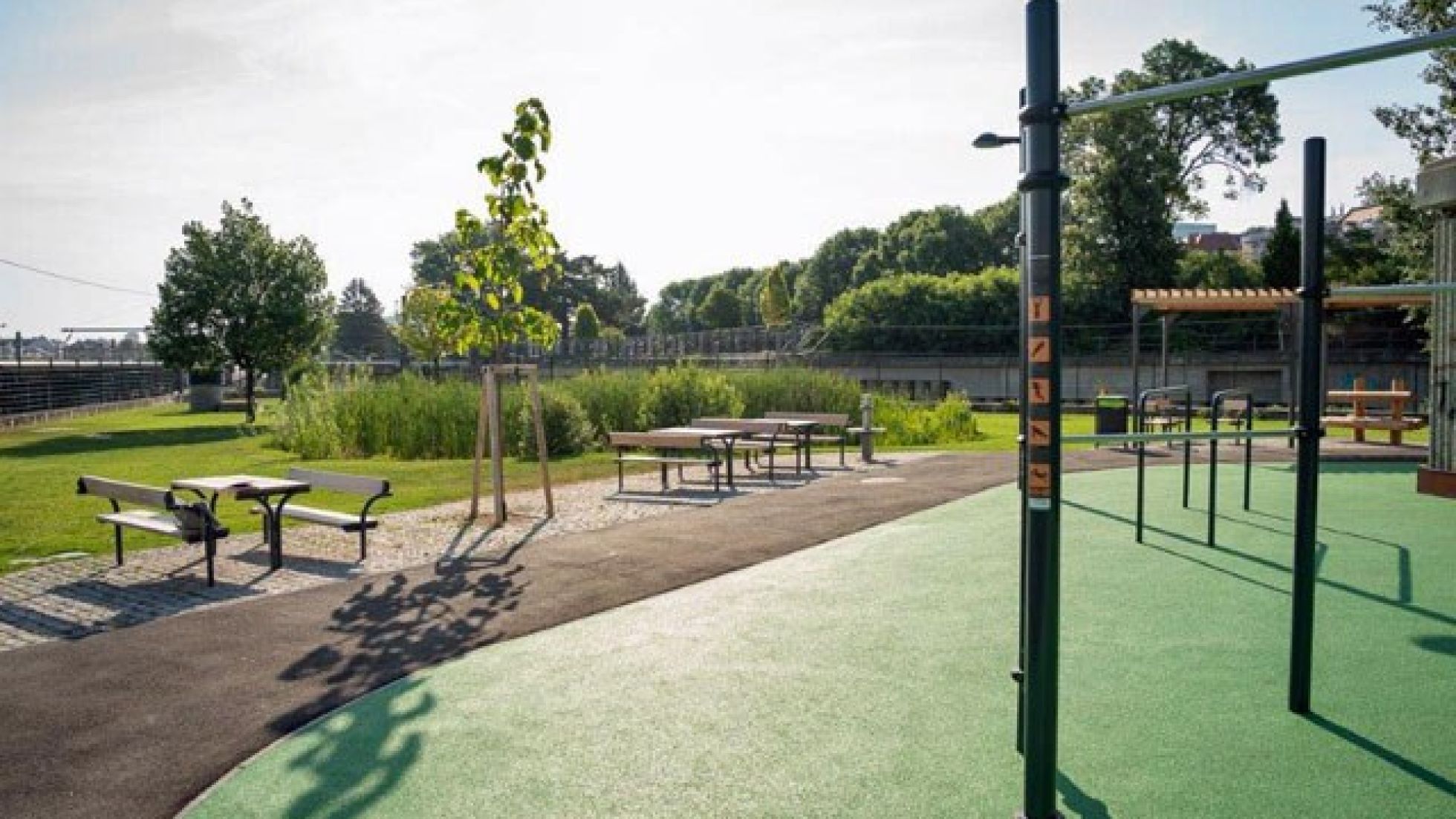 Sitzmöbel und Calisthenics-Anlage in einem Park