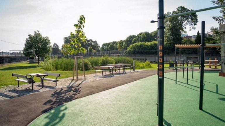 Sitzmöbel und Calisthenics-Anlage in einem Park