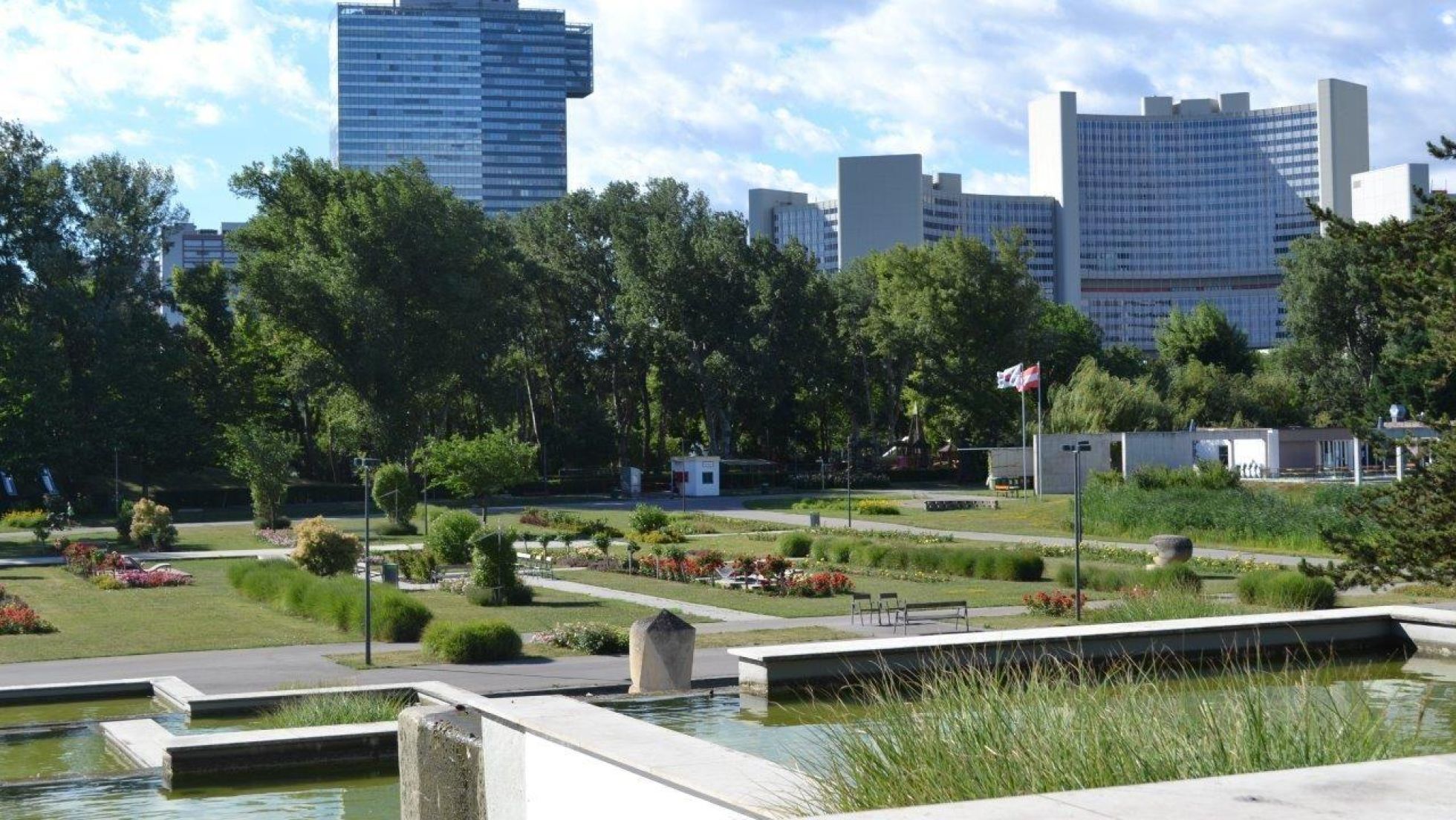 copyright: Souczek Park with rectangular, tiered fountains and high-rise buildings in the background