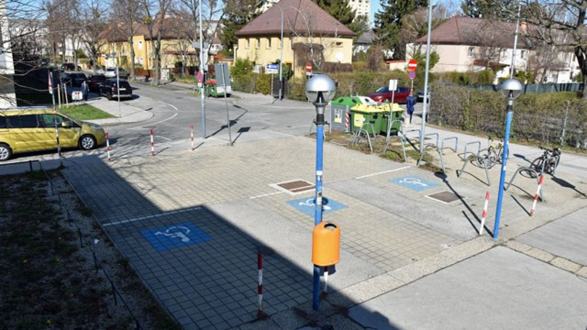 Blick von oben auf 3 Behinderten-Parkplätze vor dem Donaustädter Bad