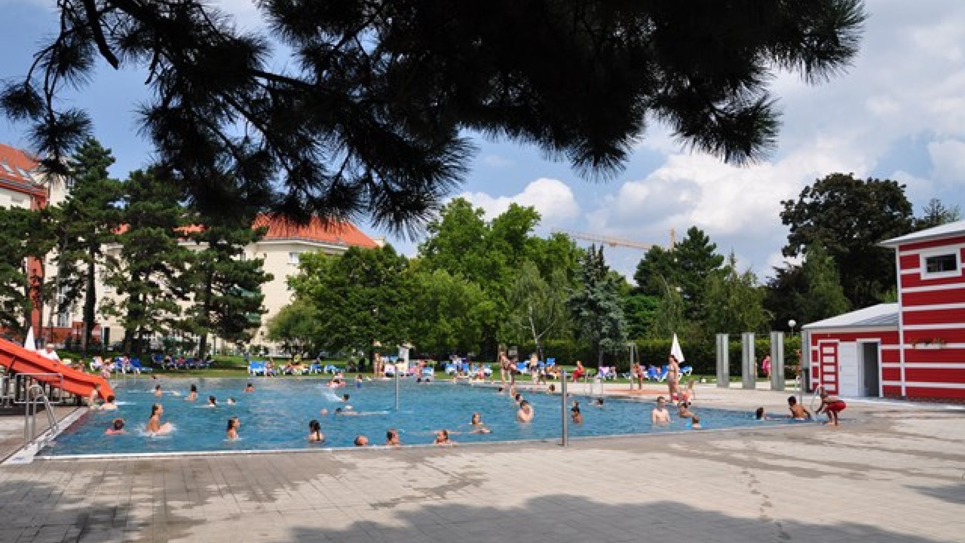 Kinderbecken im Freien und badende Menschen