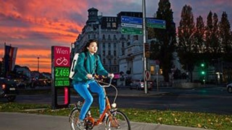 Junge Radfahrende passiert die Fahrradzählstelle am Karlsplatz