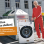 copyright: Philipp Horak Herbert Prohaska in einem roten Trainingsanzug neben einer Waschmaschine, links eine weiße Box mit dem Schriftzug "Jo ned ins Abseits stellen", darunter eine orange Box mit dem Schriftzug "Bring den Sperrmüll zum Mistplatz, sonst mindestens € 600 Strafe!"