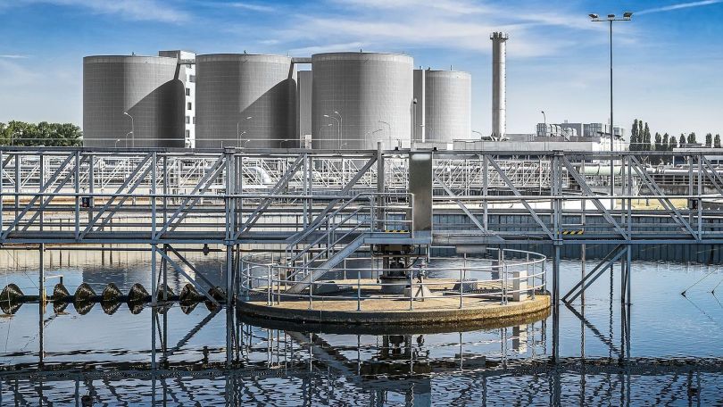 copyright: Christian Houdek Wasser in einem großen Klärbecken, dahinter stehen große Wassertanks