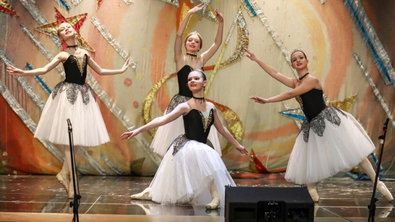 copyright: Galina Skopa Four young ballet dancers on stage.