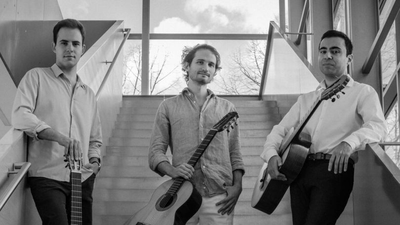 Schwarzweiß-Foto des Cross Atlantic-Trios aus Treppenbsatz stehend