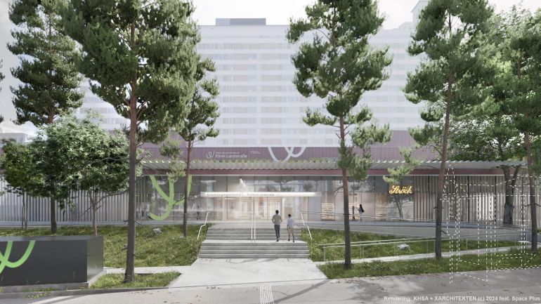 copyright: Haas Haas Architektur + X Architekten Platz vor dem Eingang zur Klinik Landstraße mit einem breiten Weg und vielen Bäumen. Zum Eingang führen mehrere Stufen, auf der rechten Seite ist eine barrierefreie Rampe.