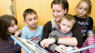 Woman with children reading a book