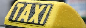 Taxi sign on roof of a car