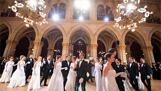 People dancing at a ball in Vienna City Hall.