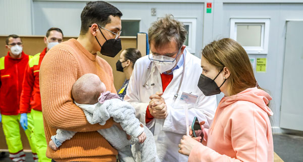 doctor talking to a couple with a baby