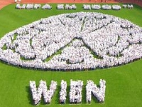 People forming the Host City Vienna Logo on the pitch of Ernst-Happel-Stadion