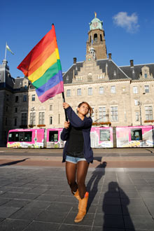 A woman waving a rainbow flag