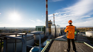 Mitarbeiter von Wien Energie blickt auf den Hochdruck-Wrmespeicher und das Kraftwerk Simmering