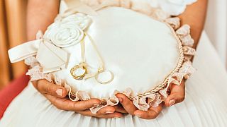 hands holding a cushion with rings